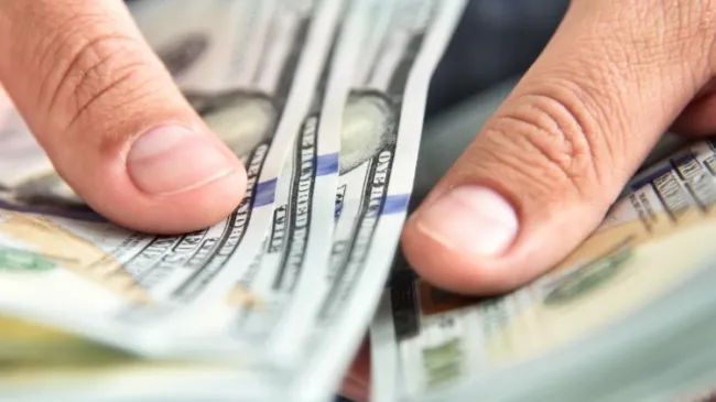 hands holding cash